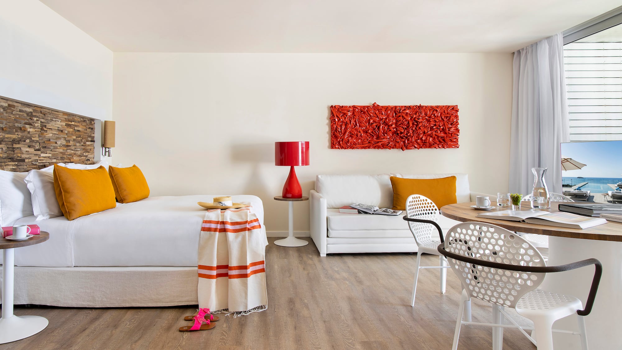 a room with a bed and a table and chairs