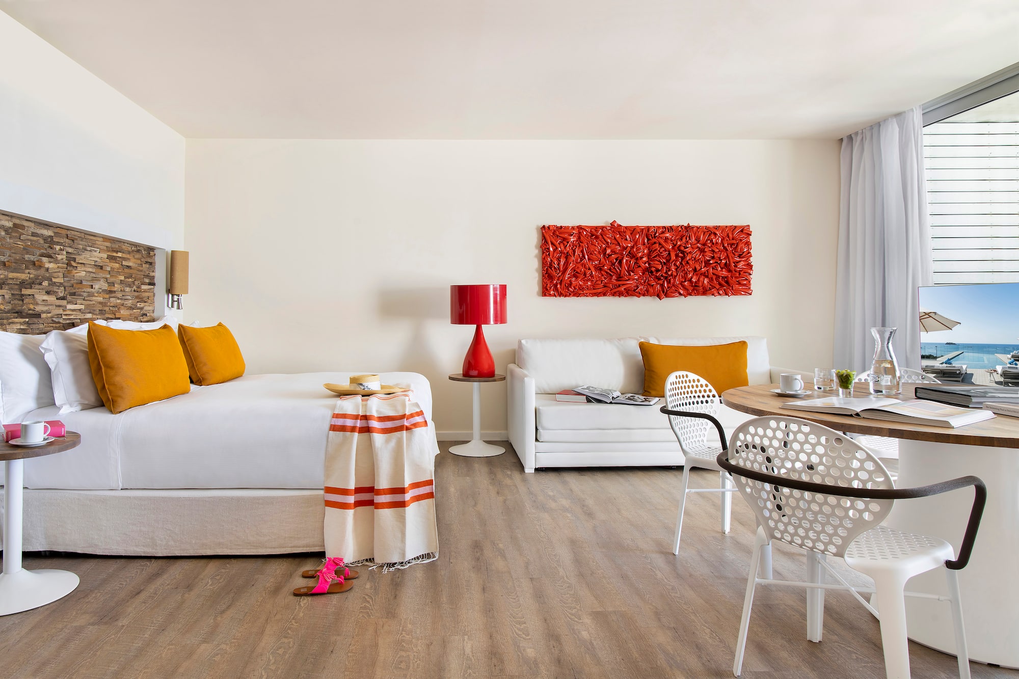 a room with a bed and a table and chairs