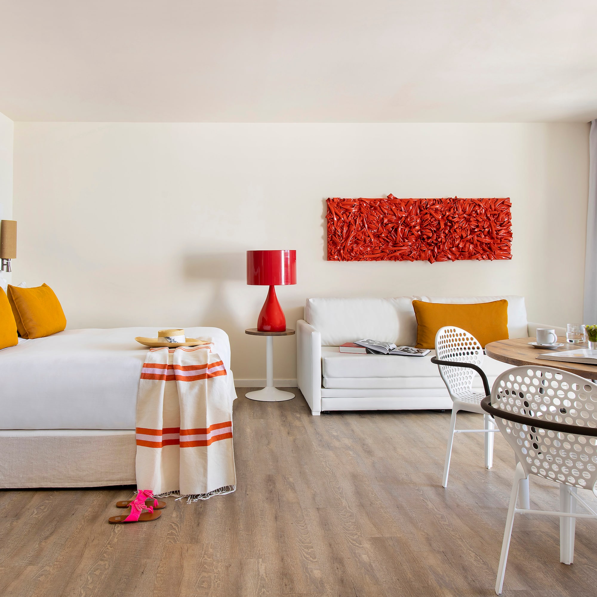 a room with a bed and a table and chairs