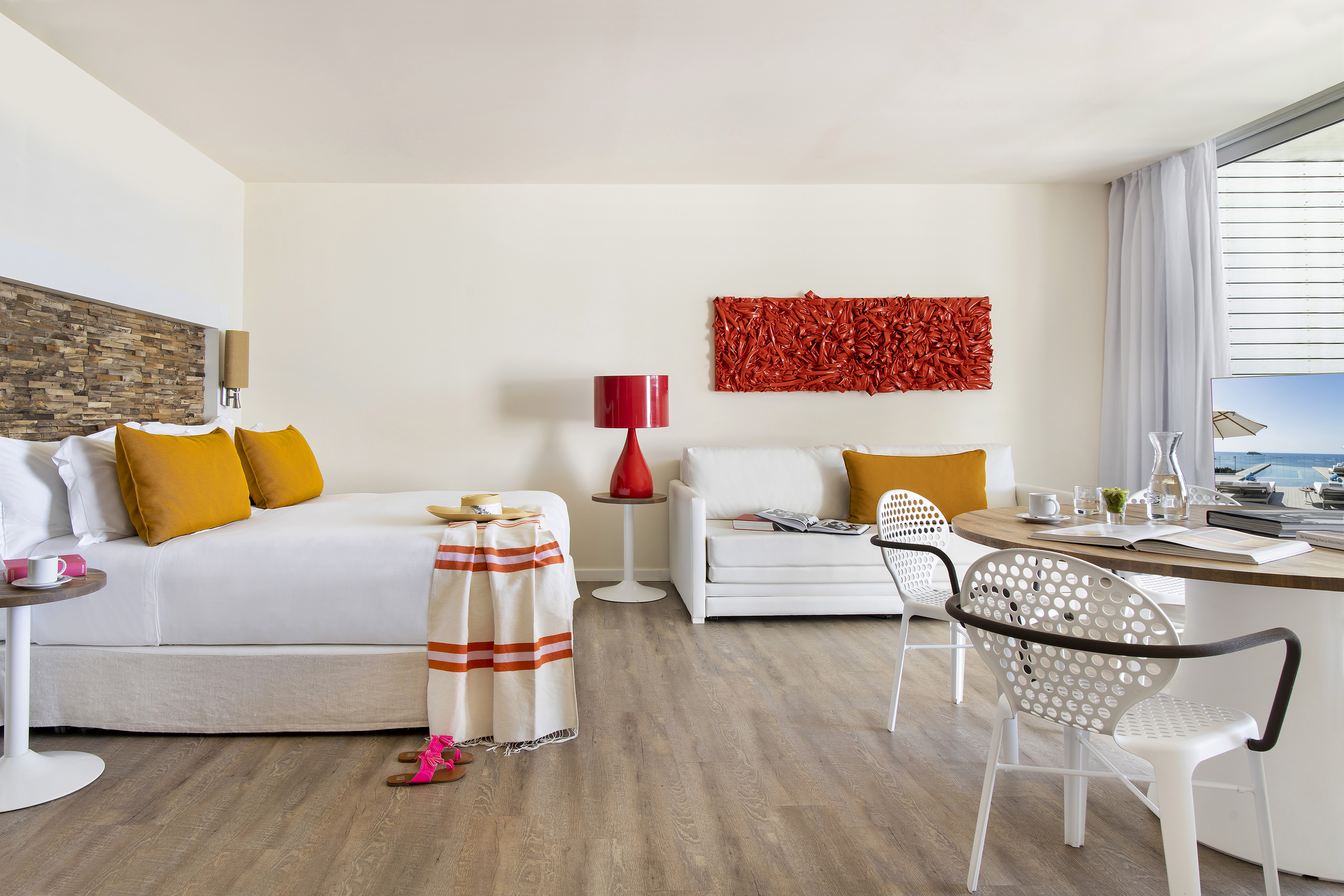 a room with a bed and a table and chairs