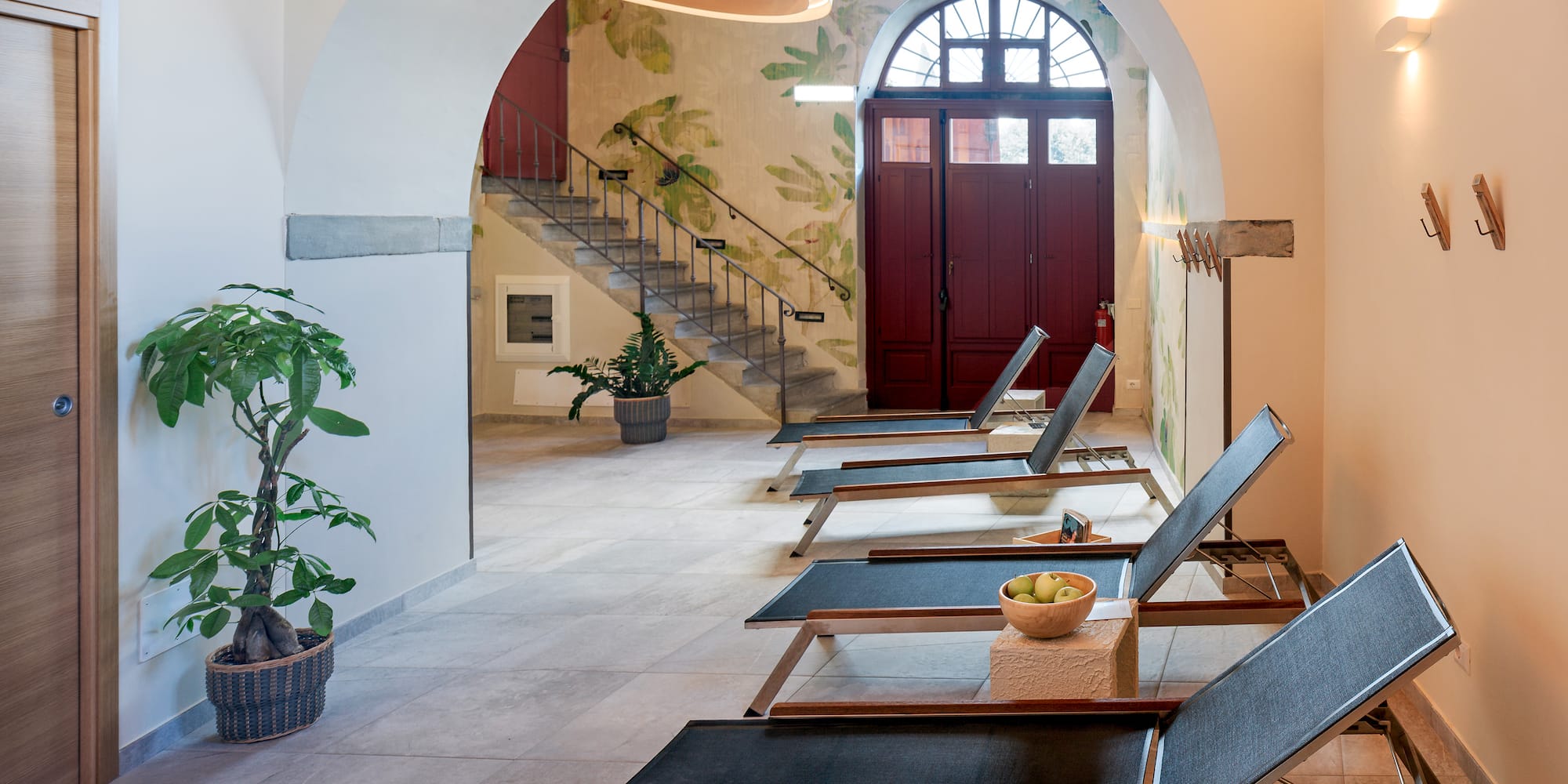 a room with chairs and a staircase