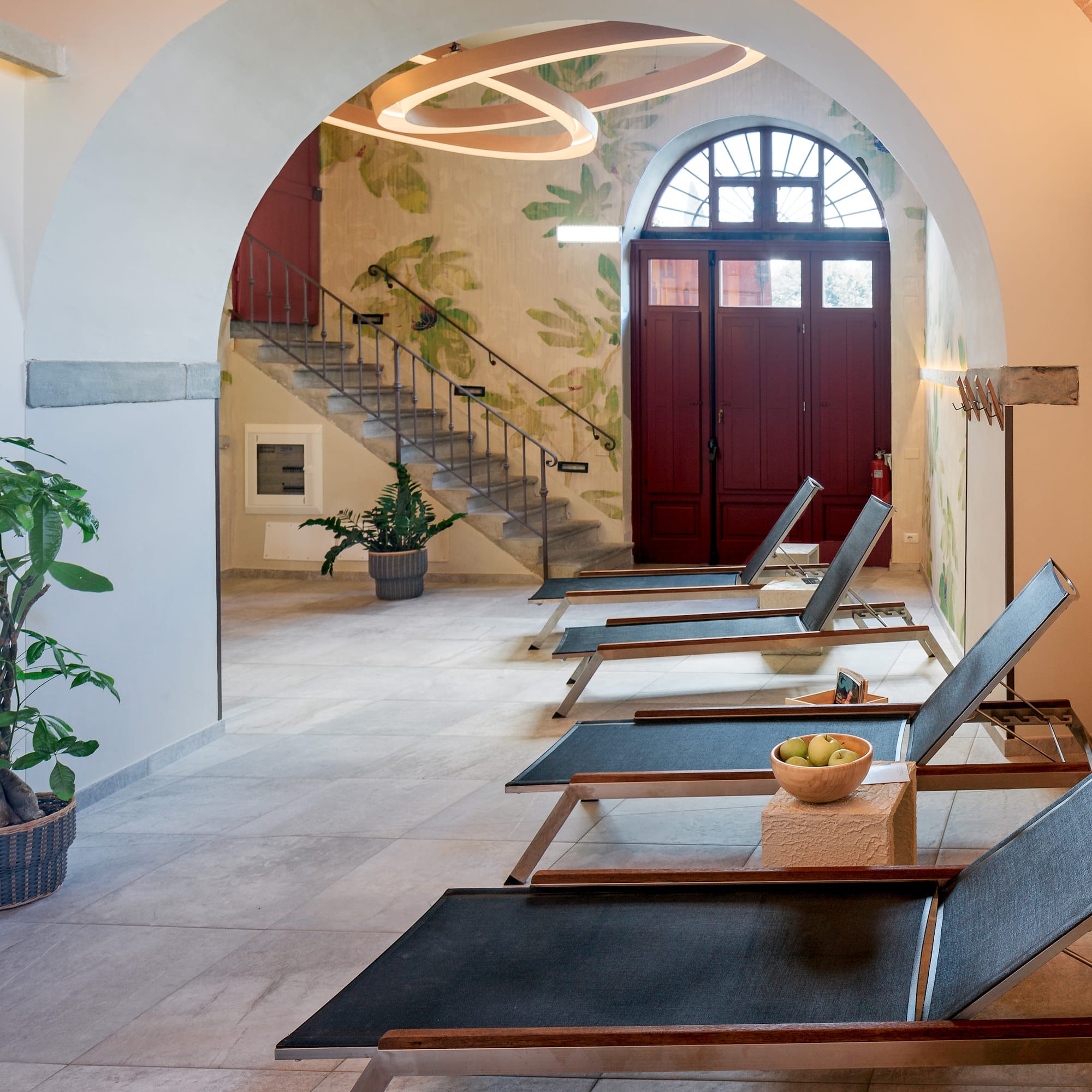 a room with chairs and a staircase