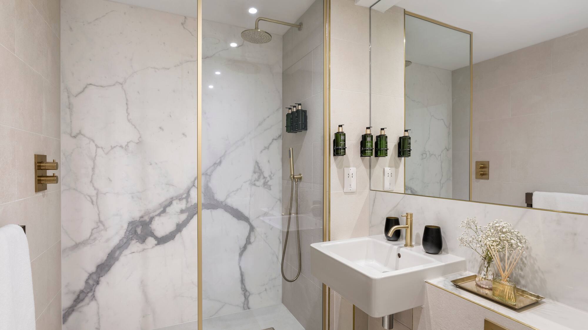 a bathroom with a shower and sink