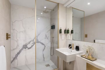 a bathroom with a shower and sink