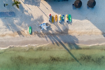 a beach with boats and a plane