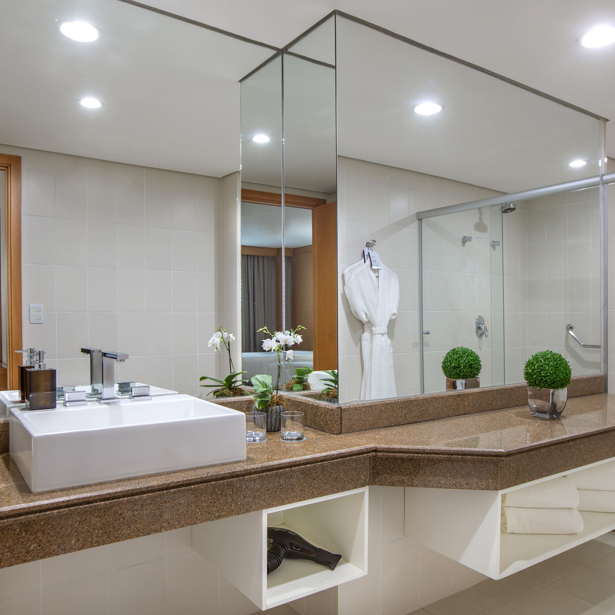 a bathroom with a large mirror and a sink