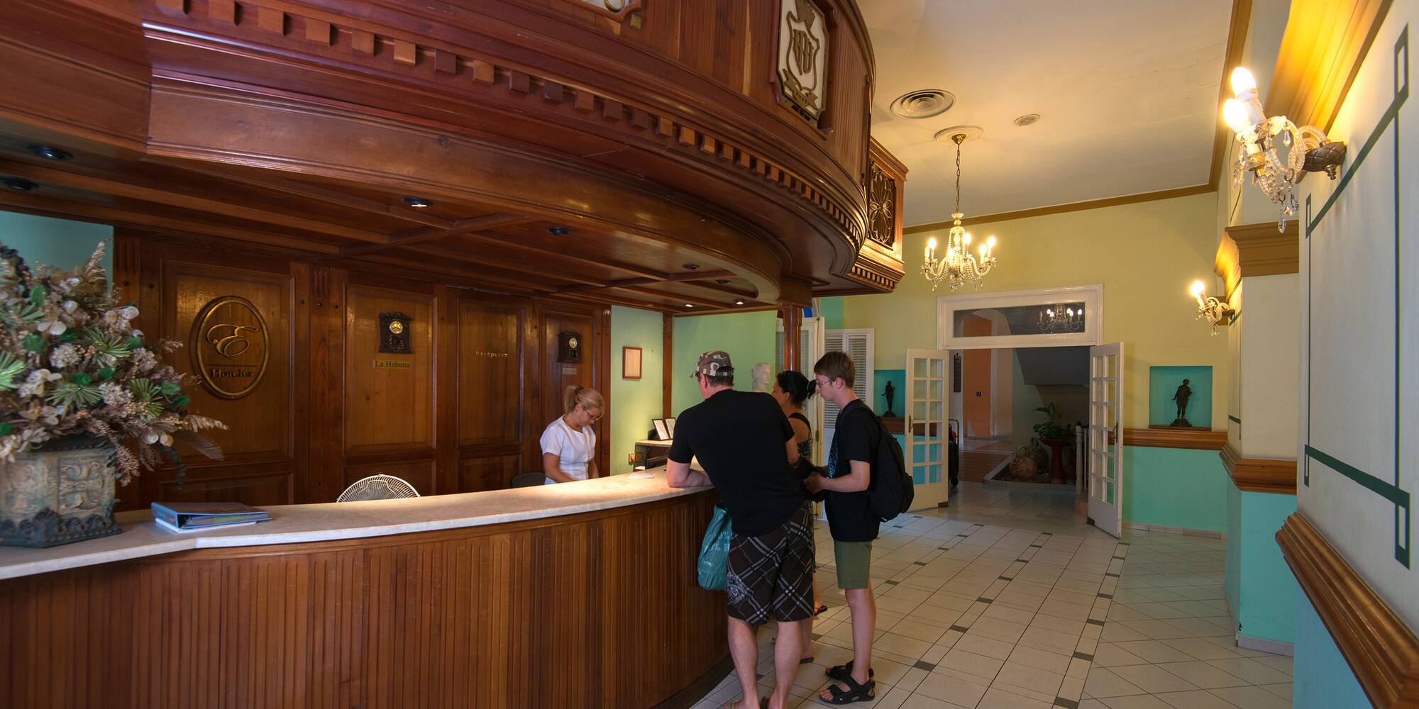 a group of people standing at a reception desk