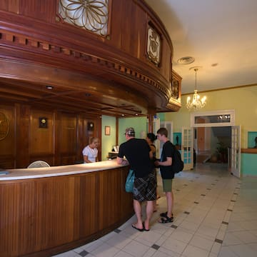 a group of people standing at a reception desk