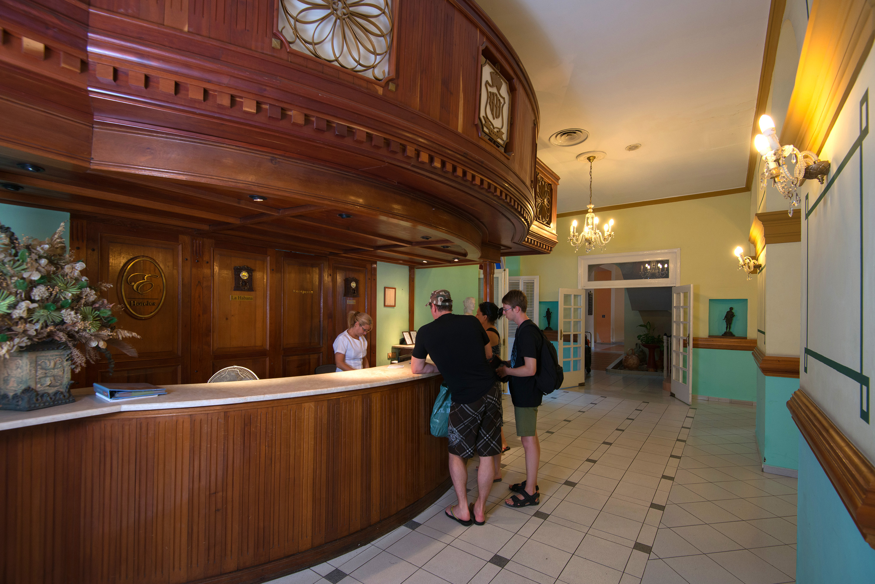 a group of people standing at a reception desk
