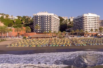 a beach with chairs and a body of water