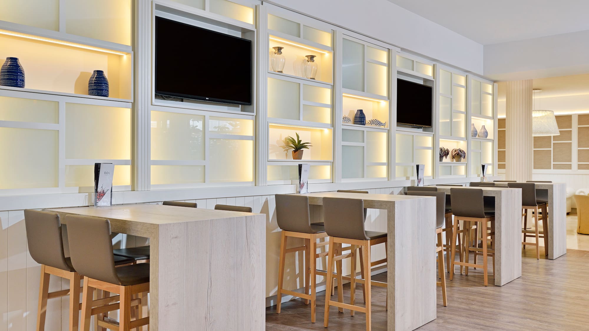 a room with white cabinets and tvs