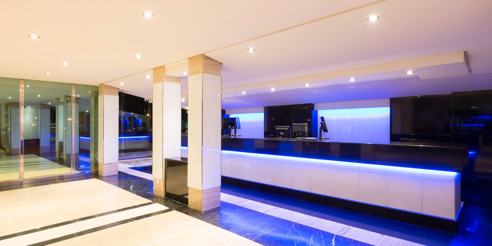 a lobby with blue lights and a reception desk