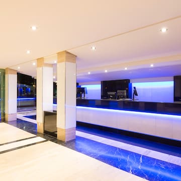 a lobby with blue lights and a reception desk