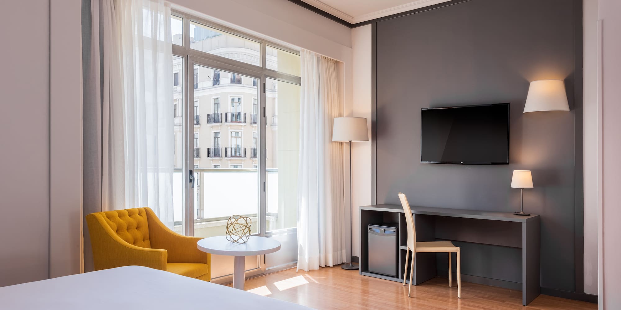 a room with a bed and a tv