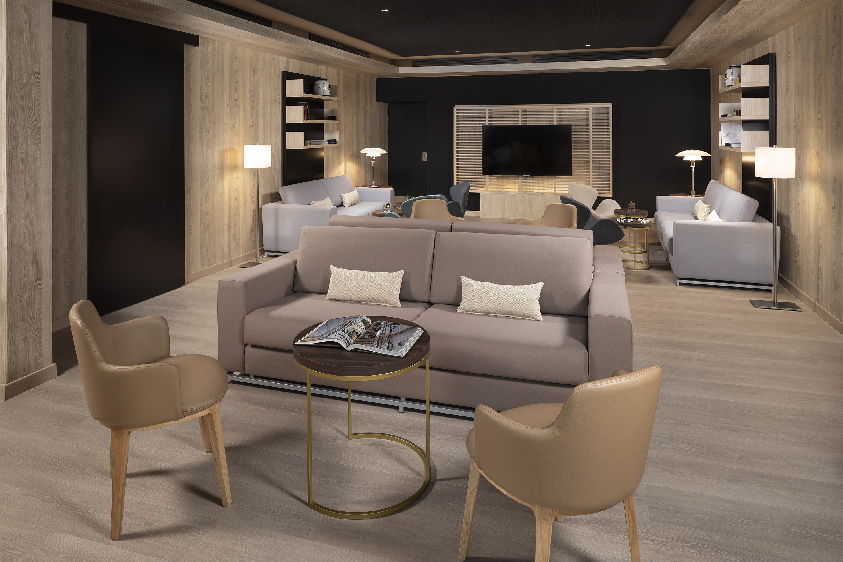 Modern lounge with comfortable sofas, wood walls, and contemporary decor.