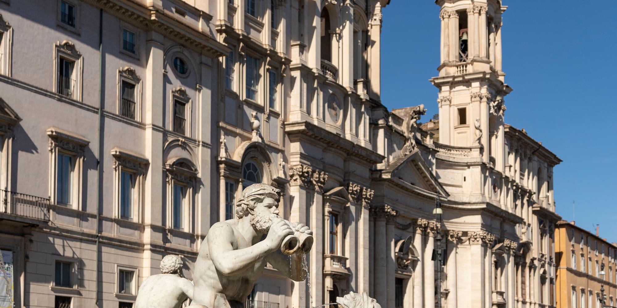 a fountain with statues in front of a building