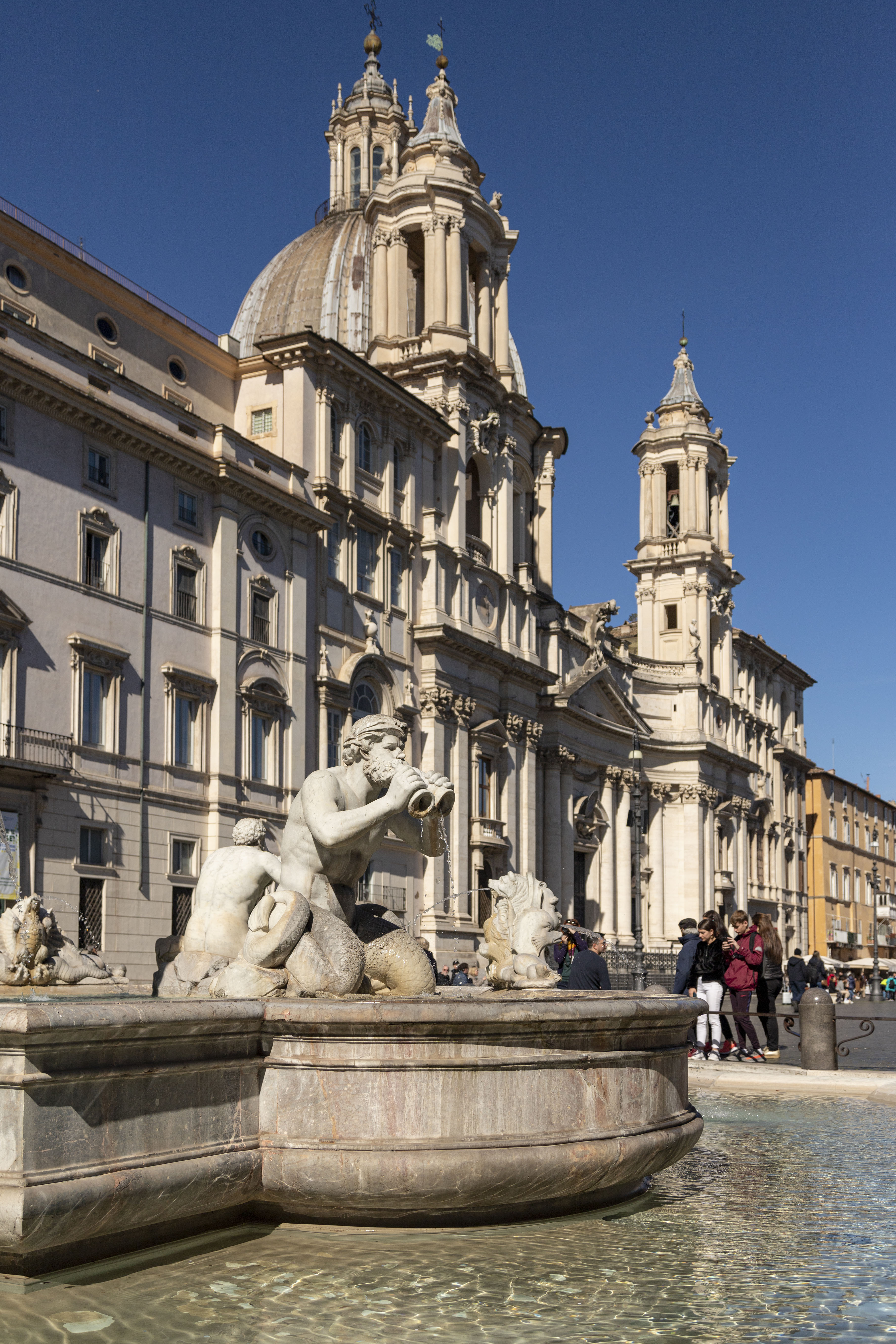 Fontana del Nettuno in Piazza Navona, Rome, with Sant'Agnese in Agone church.