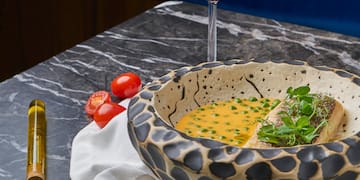 a bowl of soup and a glass of wine