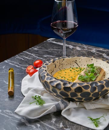 a bowl of soup and a glass of wine