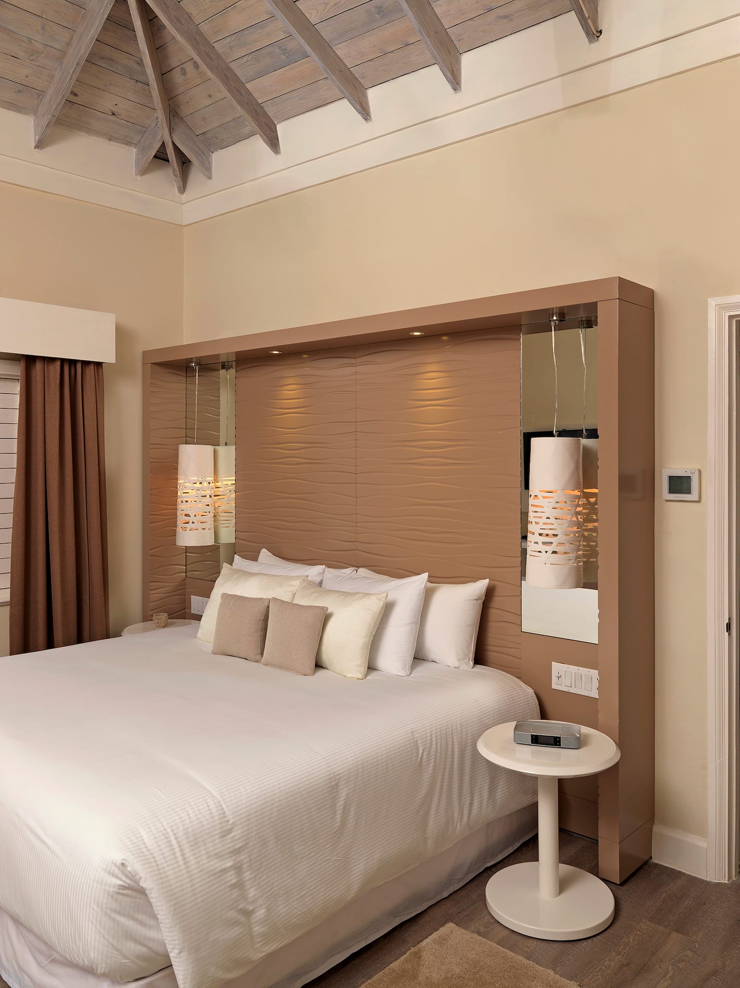 a bedroom with a bed and a wood floor