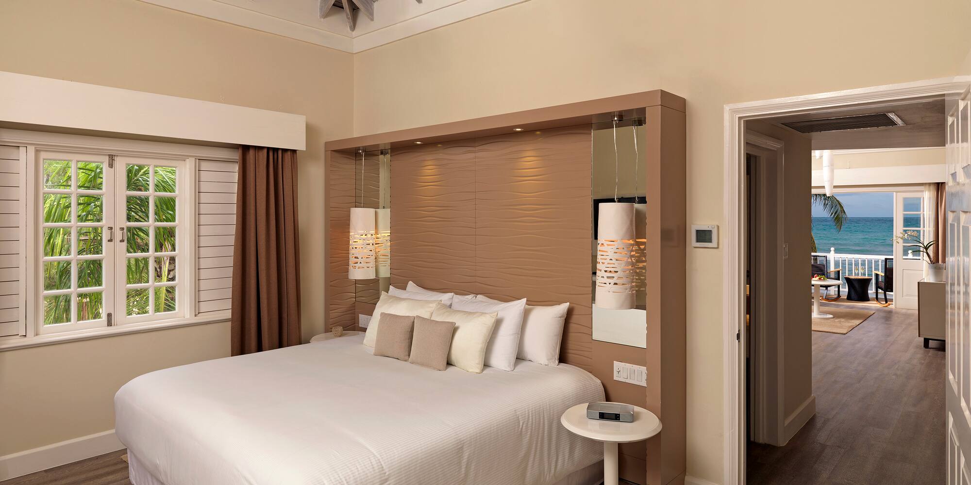 a bedroom with a bed and a wood floor