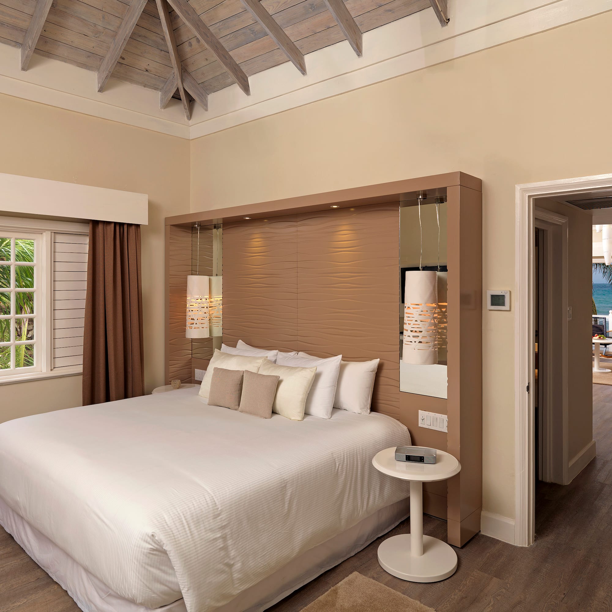 a bedroom with a bed and a wood floor