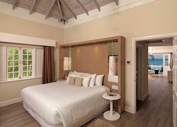 a bedroom with a bed and a wood floor