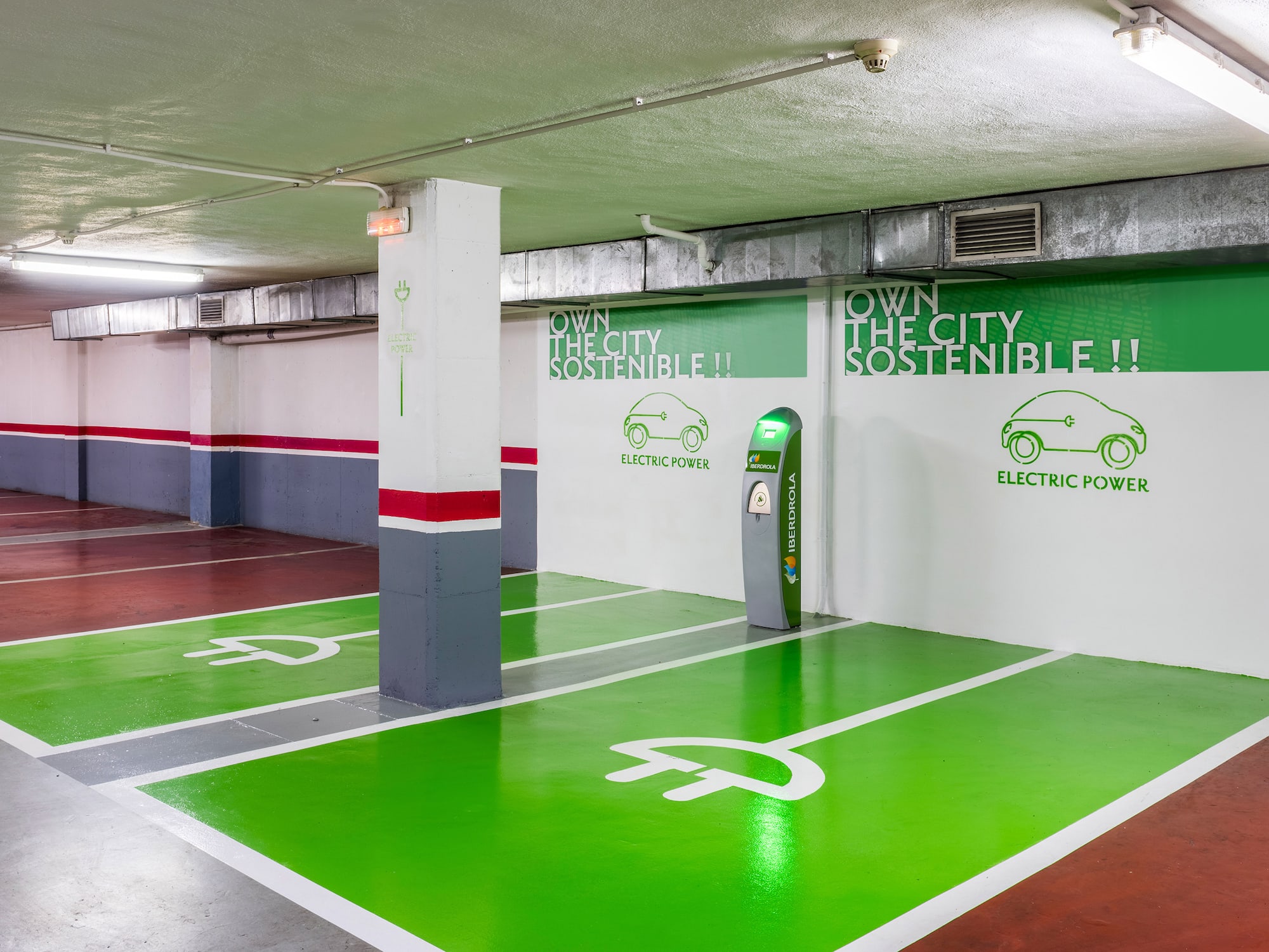 an empty parking garage featuring a green and white painted floor