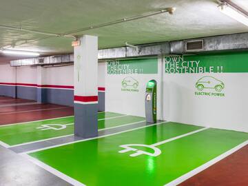 an empty parking garage with green and white painted floor