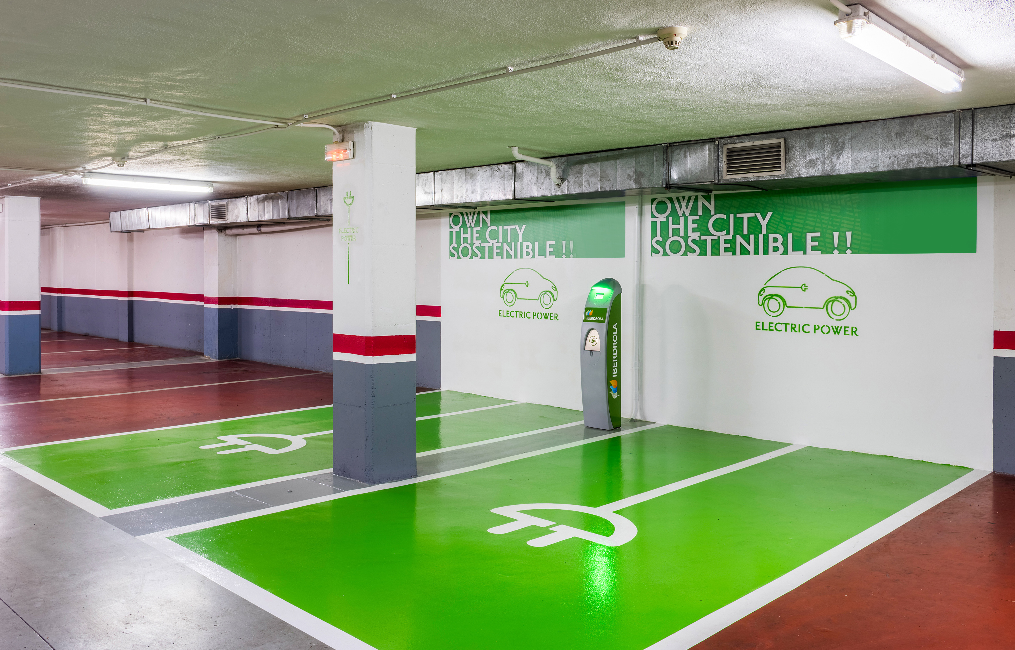 an empty parking garage featuring a green and white painted floor