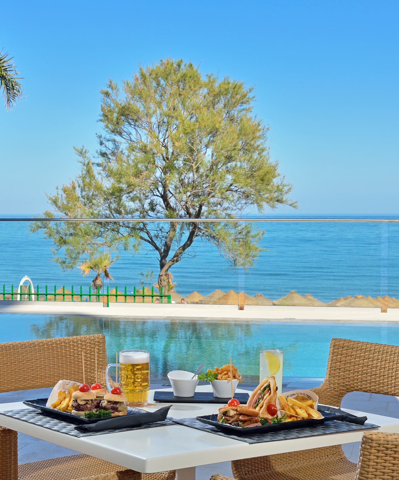 a table with food on it and a pool in the background