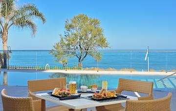 a table with food on it and a pool in the background