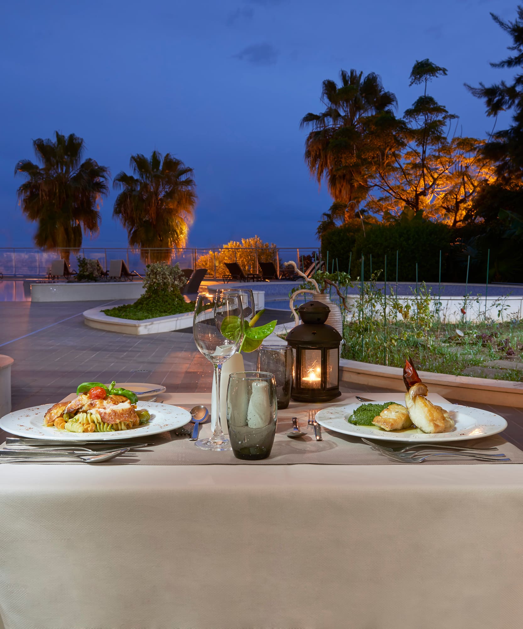 a table with plates of food and a candle on it
