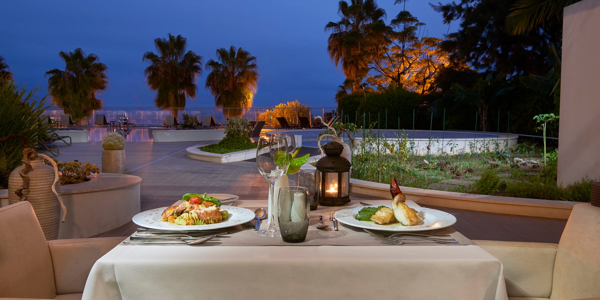 a table with plates of food and a candle on it