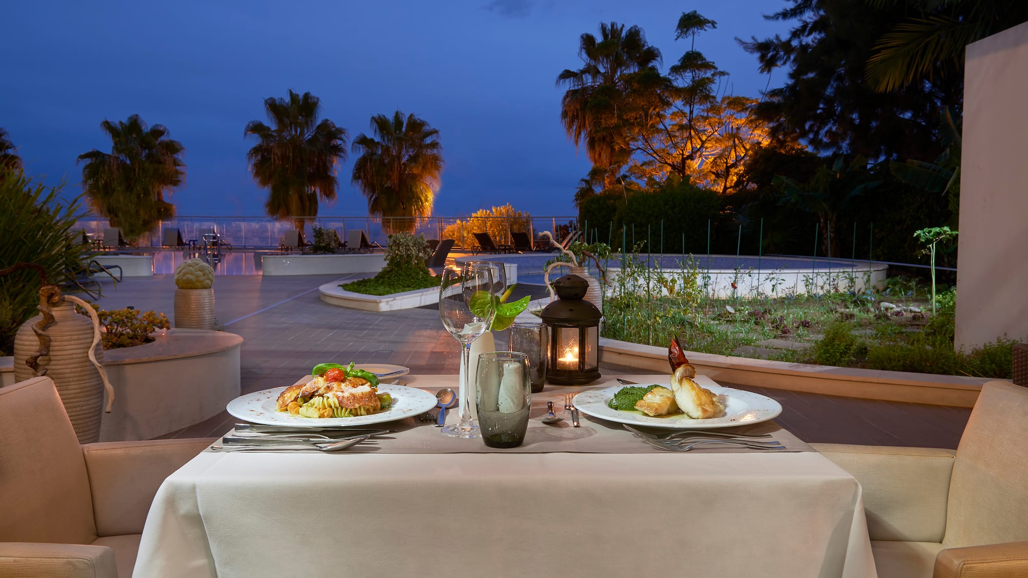a table with plates of food and a candle on it