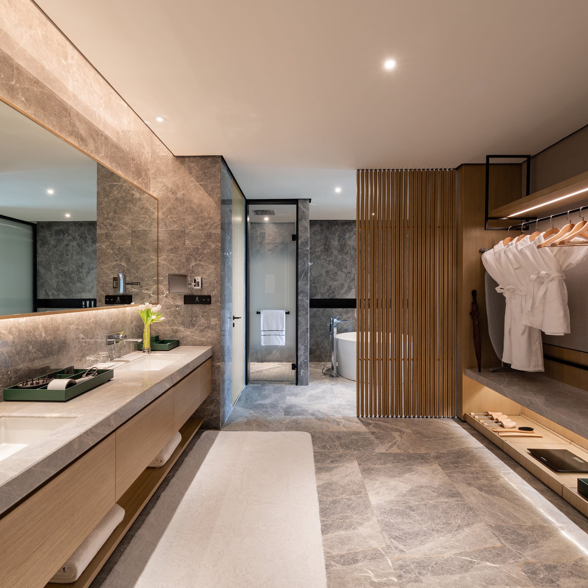 a bathroom with marble countertops and a large mirror