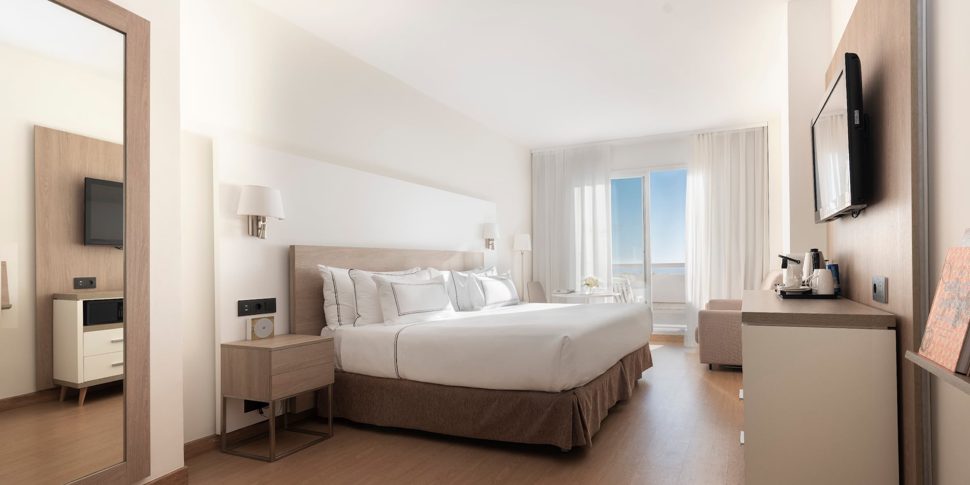 a bedroom with a large bed and a wood floor