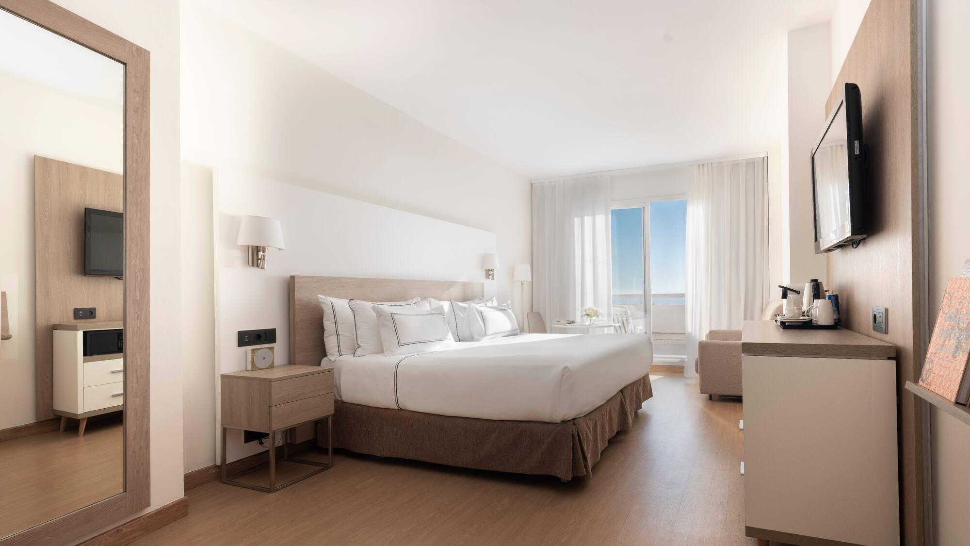 a bedroom with a large bed and a wood floor