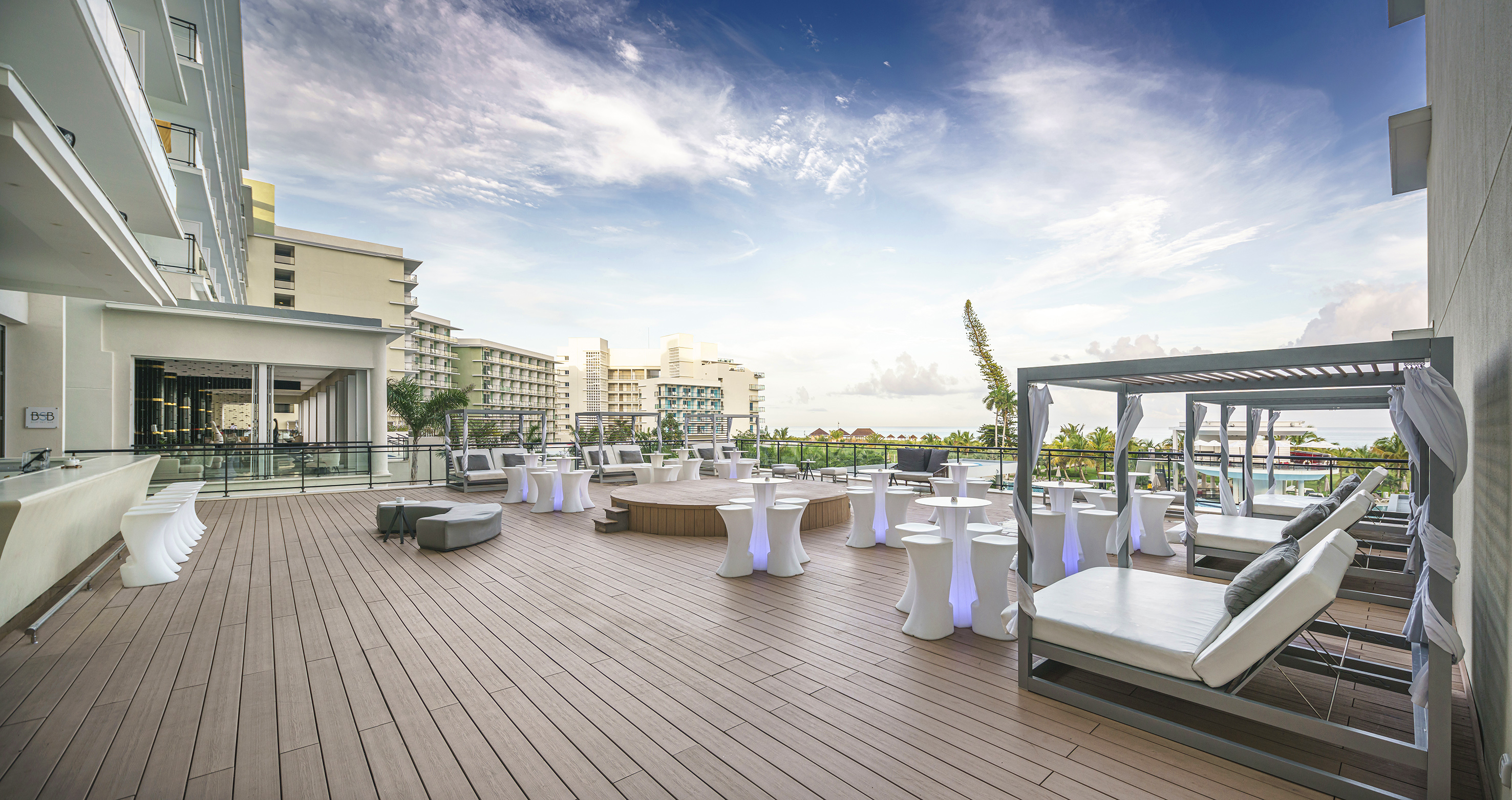 a deck with tables and chairs on it