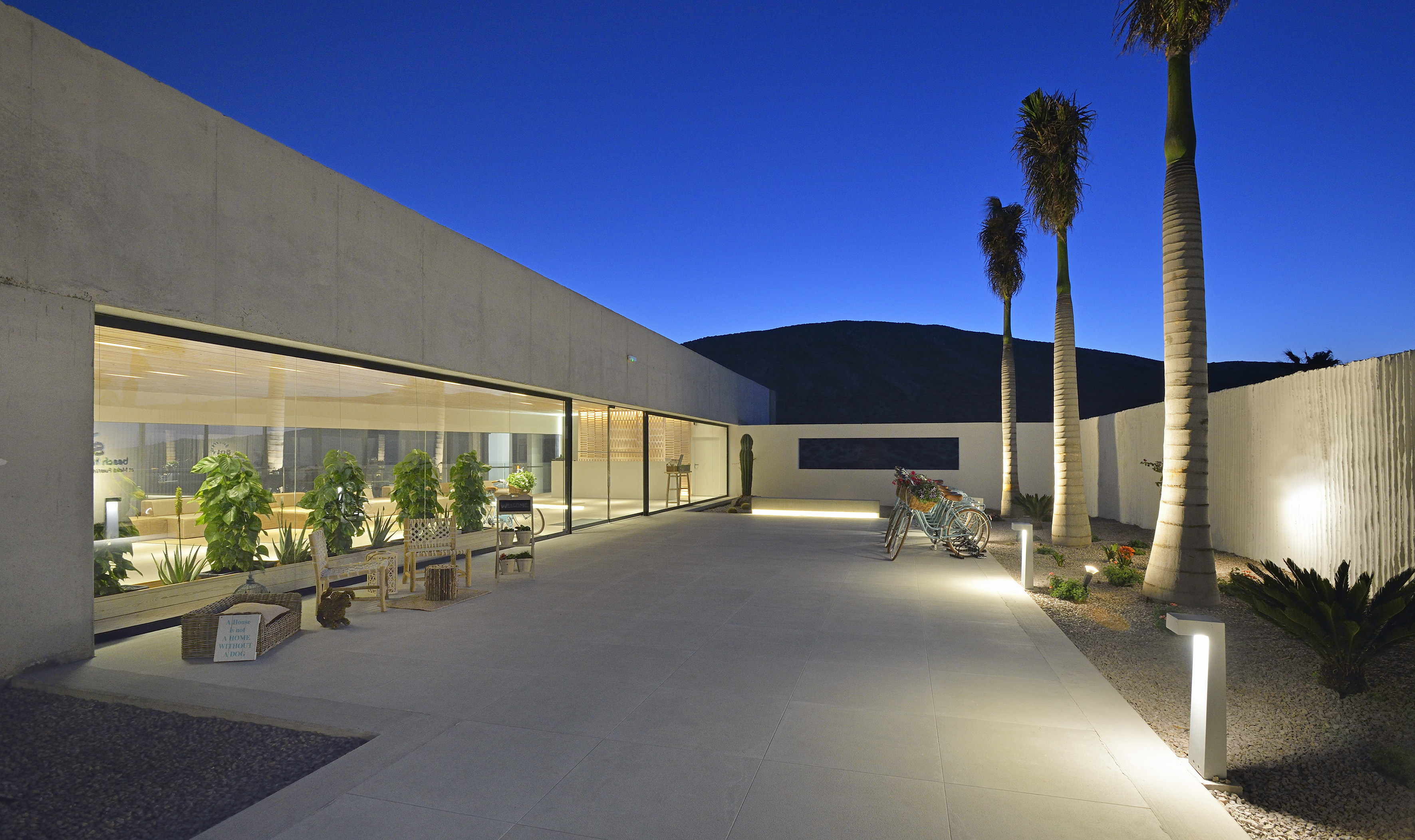 a building with a glass wall and trees