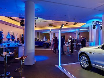 a room with a group of people and cars