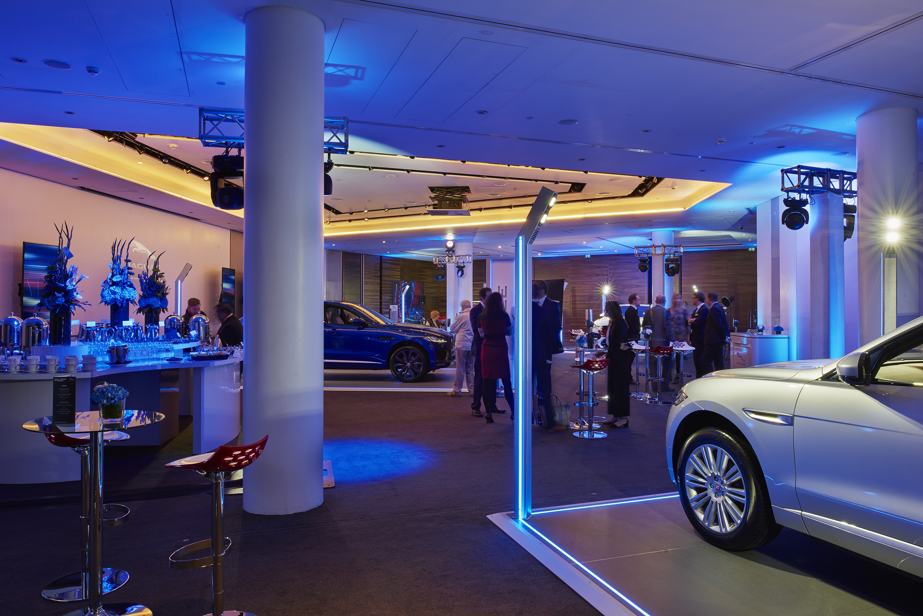 a room with a group of people and cars