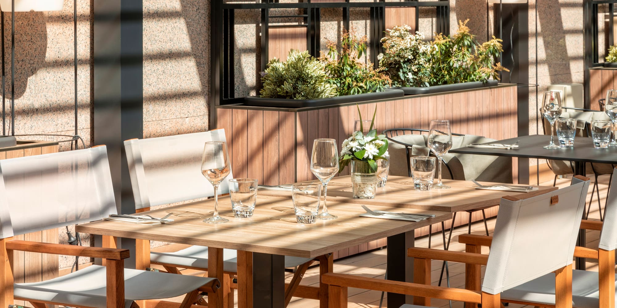 a table with chairs and glasses on it