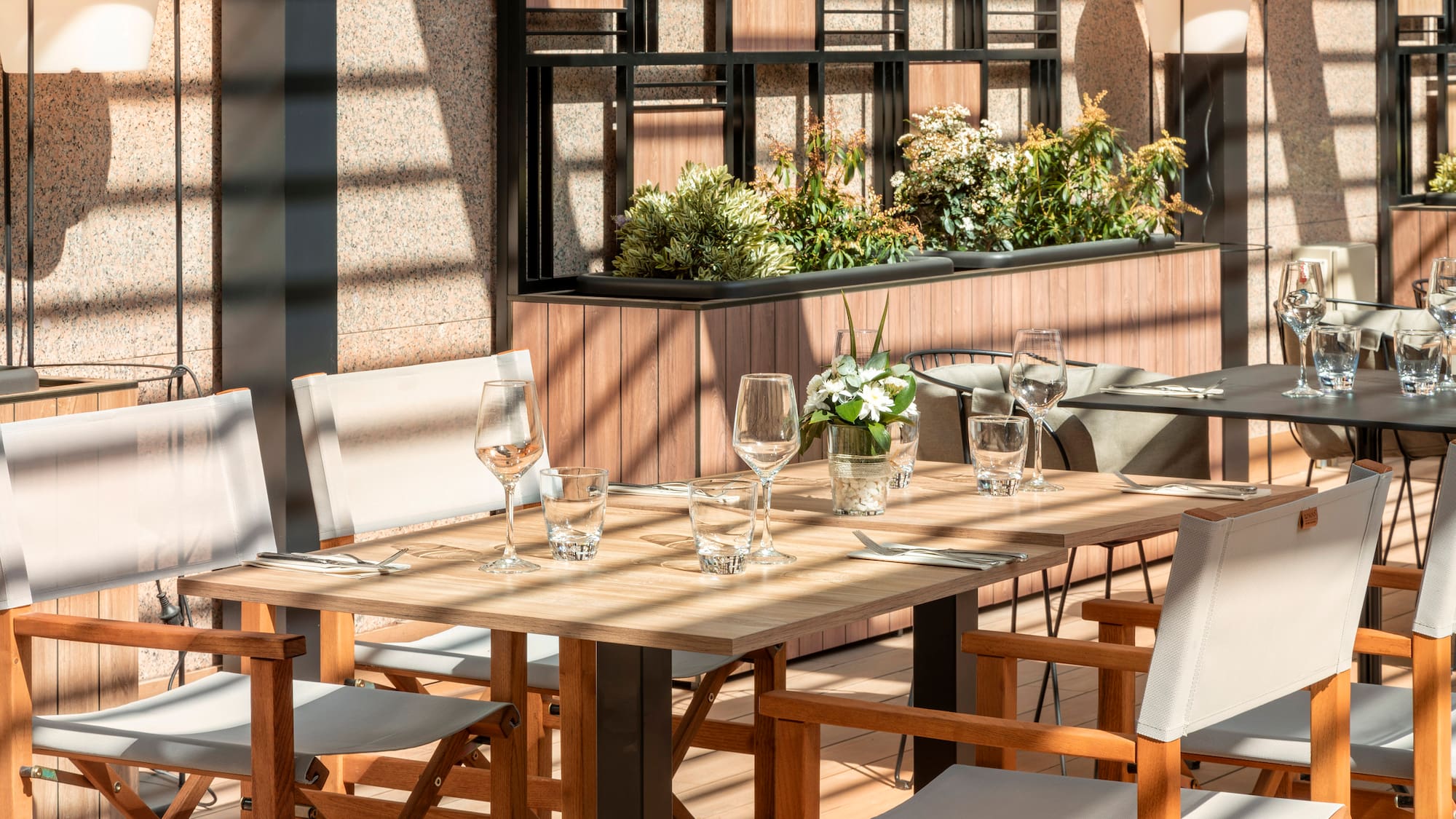 a table with chairs and glasses on it