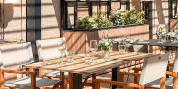 a table with chairs and glasses on it