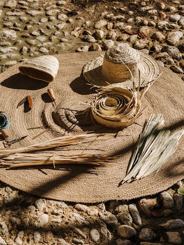 a straw hat and other items on a rug
