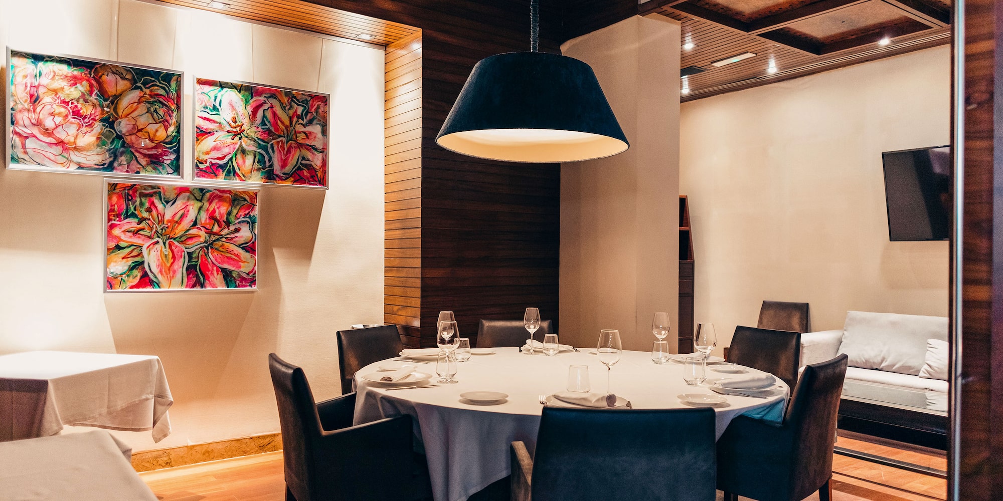 a room with a round table and chairs