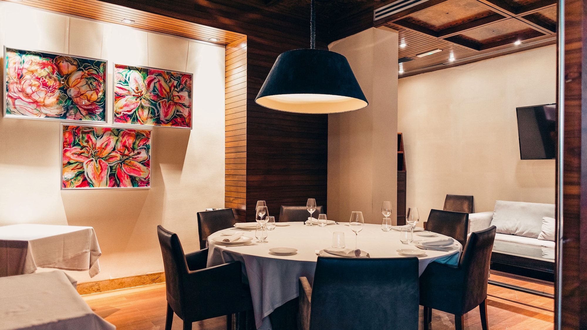 a room with a round table and chairs