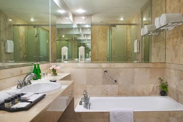 a bathroom with a bathtub and a mirror