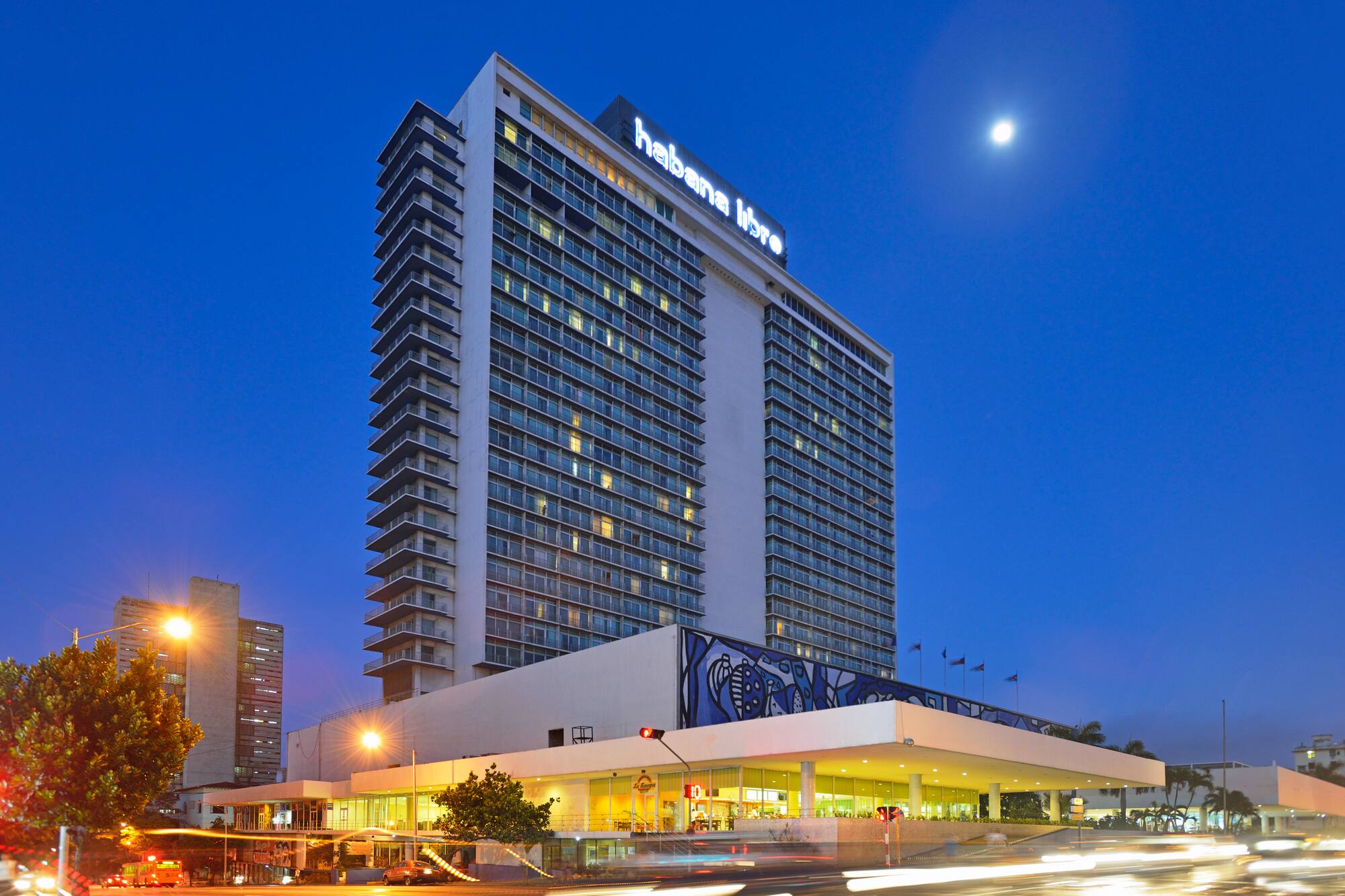 a large building with many windows with Hotel Tryp Habana Libre in the background